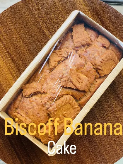 A single Biscoff banana tea cake, wrapped and ready to be delivered. This loaf cake is moist and flavorful, with the sweet spice of Biscoff in every bite.