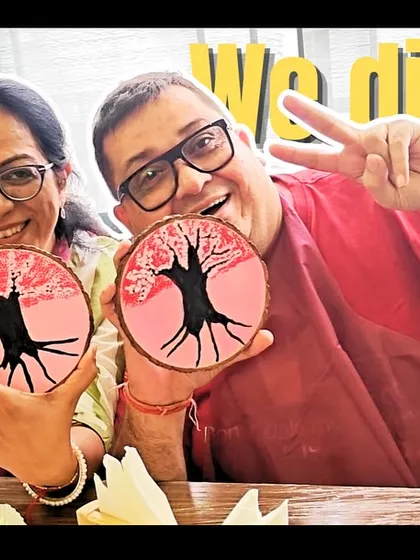 "We did it!" The proud creators showing off their matching cherry blossom wood slice paintings from a private birthday workshop.