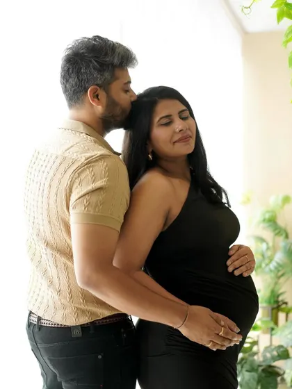 A quiet embrace from behind, showing support and love in a naturally lit studio setting.