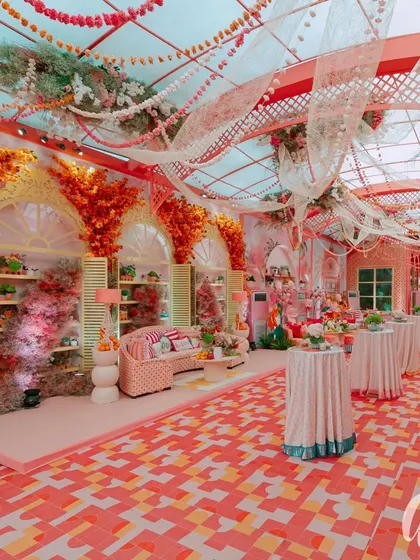 A wide view of the daytime event space, showing the patterned floor, draped ceiling, and distinct seating zones. This demonstrates how we structure a large space to feel both grand and intimate.