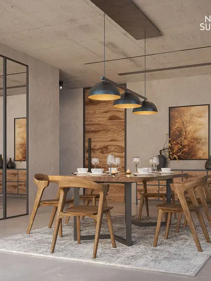 A dining space that encapsulates the minimalist charm of Brutalist architecture. The design features a solid wood table and chairs, set against raw concrete-finish walls and a large mirrored panel that adds depth.