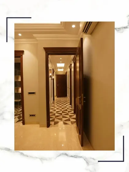 Beyond walls, we create experiences. This hallway, with its checkerboard marble floor and series of solid wood doors, is designed to be an exclusive escape within your own home.