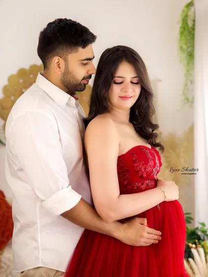 A beautiful couple's portrait in our boho studio. The husband's gentle embrace and the soft, natural light create a warm and loving atmosphere.