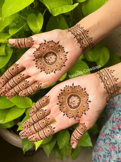 The lotus mandala design against a natural green background, highlighting the beauty of the henna art.