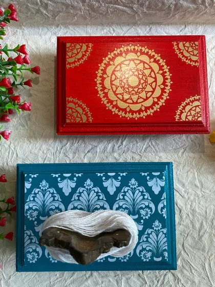 A set of my hand-painted pooja chowkis. The red one features a mandala design, while the teal one has a damask pattern and space for clay footprints.