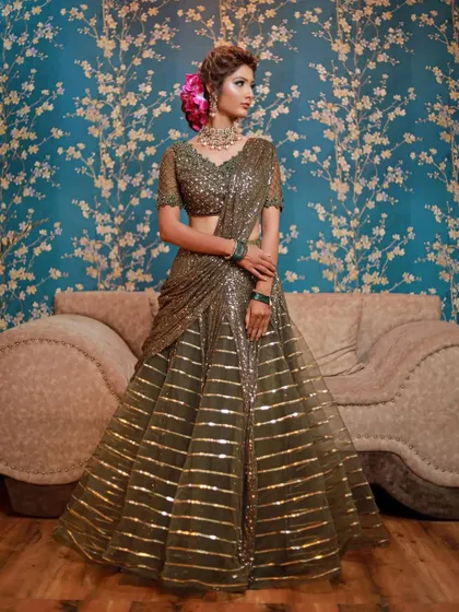 This olive green sequin lehenga-saree is a unique choice for a reception. I've paired it with a polki choker and green bangles to create a cohesive and stylish ensemble.