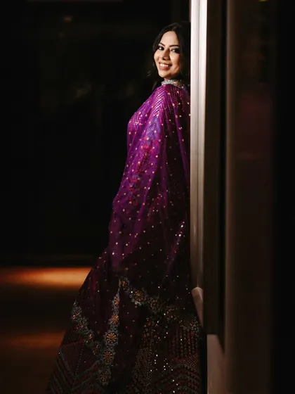A beautiful, smiling portrait of the bride, capturing her joy and the elegance of her sangeet attire.