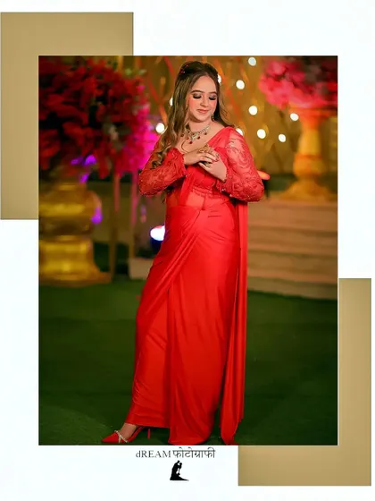 A portrait of Nisha in a stunning red saree, her pose exuding confidence and glamour.