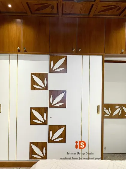 The custom wardrobe in the traditional bedroom, featuring sliding doors with a unique leaf-motif inlay that matches the headboard design.