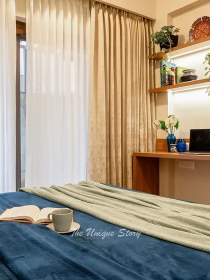 A view from the bed towards the study nook, showcasing the floating desk and shelves illuminated by an integrated LED light strip. This setup provides a perfect spot for work or study without cluttering the room.