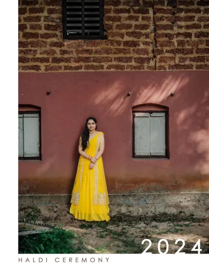 A stylish poster-style image of a bride from her Haldi ceremony, set against a rustic pink wall.