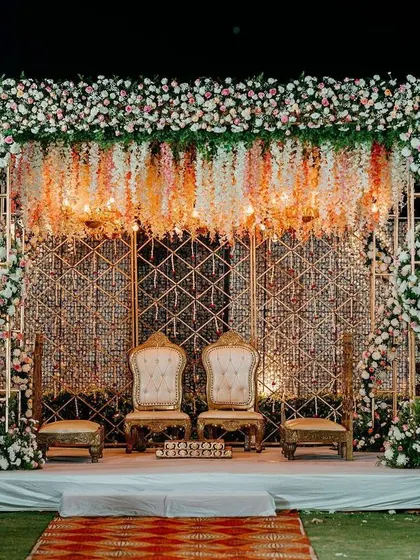 A full view of the surreal mandap, with its canopy of suspended florals, crystal-studded backdrop, and regal golden seating.