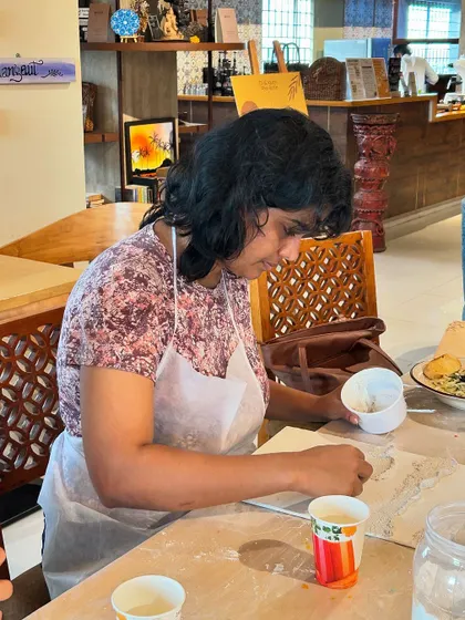 A participant working on her textured beach painting. The process is both relaxing and engaging.