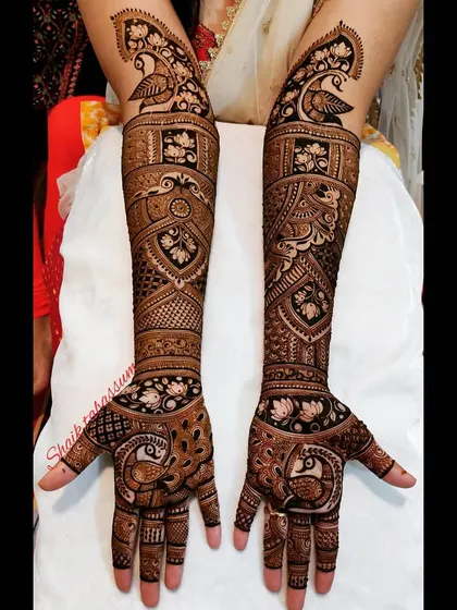 Graceful peacocks are the central theme of this design, appearing on the palms, wrists, and near the elbows, all connected by elaborate, flowing patterns.