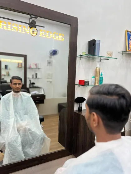 A classic side-part haircut, styled for a clean and professional appearance. This timeless look is perfect for any occasion.