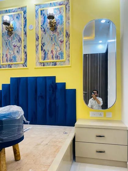 A view of the dressing table area in the master bedroom, which features a modern oval mirror.