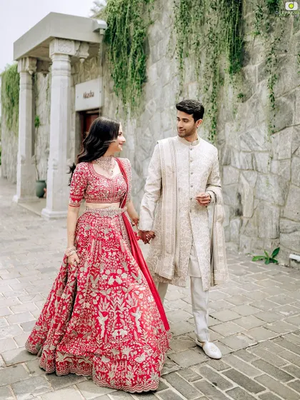 Punya and Teju walking hand in hand. This photo captures the natural and effortless feel of her makeup, which is designed to last throughout the day's events.
