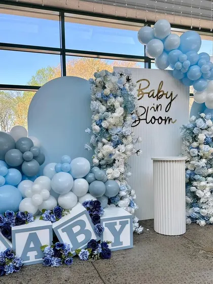 A "Baby in Bloom" theme in a beautiful blue palette. The cascading flowers and balloons create a stunning visual effect, perfect for celebrating a baby boy.