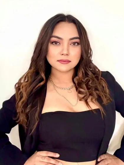 A confident and simple portrait in a black blazer and top.