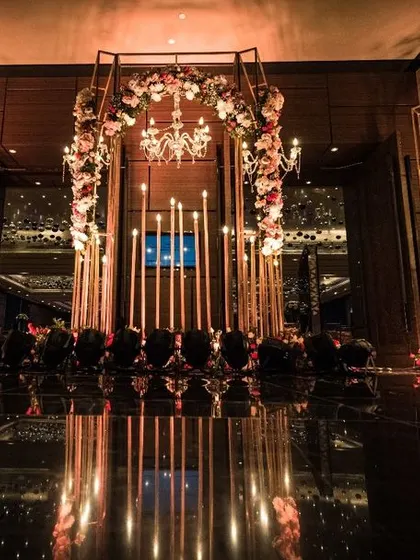 The entrance to a grand wedding reception sets the tone for the entire evening. For this event, we created a mesmerizing archway with flowers and candles, leading guests into a world of enchantment.