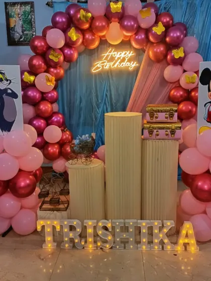 We bring cartoon themes to life for kids' parties, like this fun setup with Tom & Jerry and Mickey Mouse cutouts. The light-up name 'TRISHIKA' adds a special, personalized touch for the birthday girl.