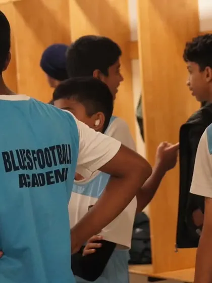 Players in the locker room, listening to instructions and mentally preparing for the match ahead.