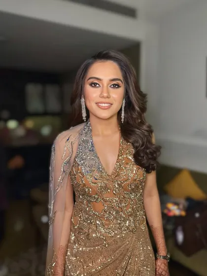 A final smiling portrait of the client. The soft waves frame her face beautifully, showing why this is such a requested look for special occasions.