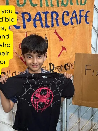Fixed! A young boy holds up his newly mended Spider-Man t-shirt. A simple patch can save a favorite piece of clothing from being discarded.