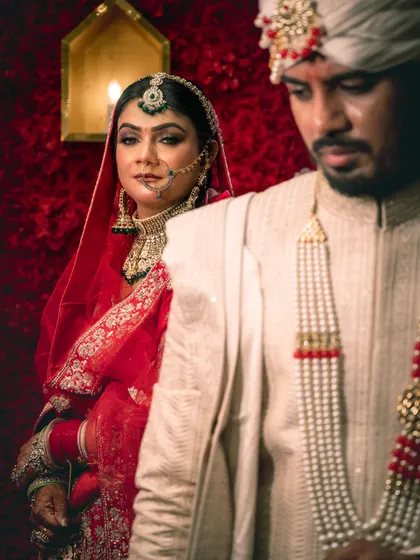 A creative portrait focusing on the bride looking over the groom's shoulder, creating a sense of depth and story.