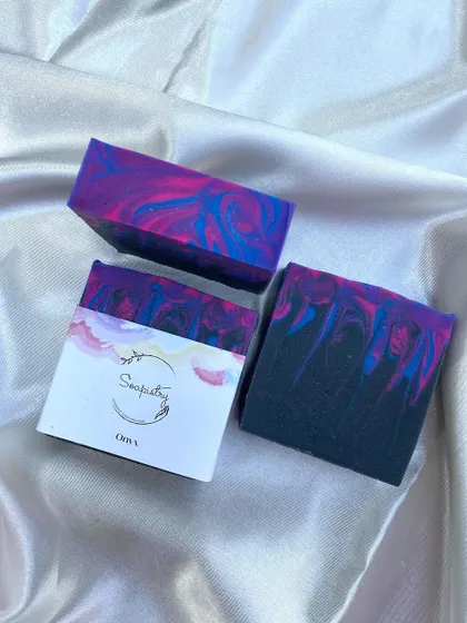 The "Onyx" soap, a dramatic mix of black, purple, and pink.