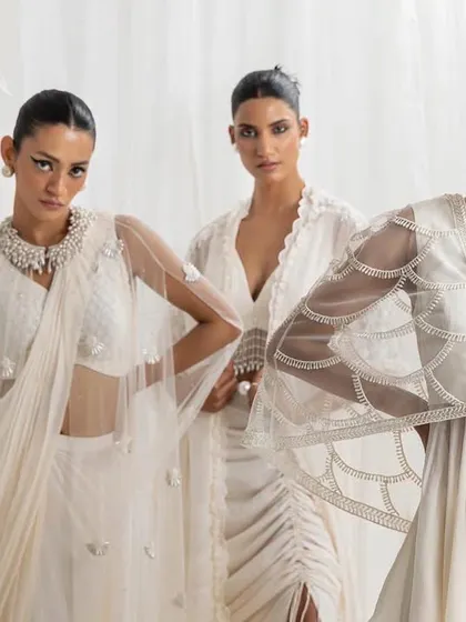 A vision in white. This image showcases three coordinated looks in ivory, featuring delicate embroidery and modern silhouettes. It demonstrates how I can create a cohesive theme for the bride and her party.