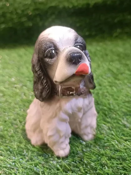 A Cocker Spaniel puppy showpiece, beautifully detailed to capture the breed's lovely features.