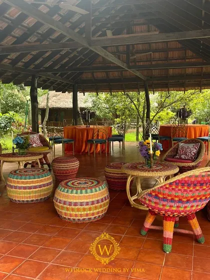 The seating for this outdoor Mehendi featured colorful woven chairs and ottomans, perfectly matching the vibrant, festive theme of the event.
