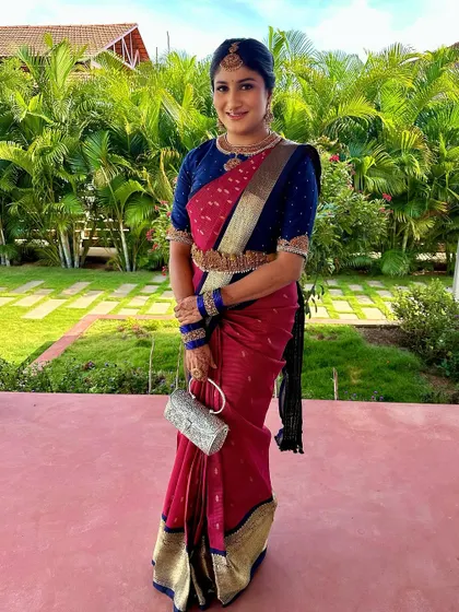 A full-length shot of the bride in her traditional attire for a pre-wedding ceremony, with makeup that is both timeless and radiant.