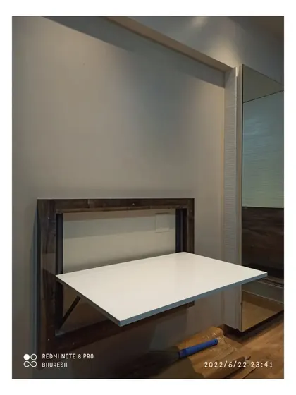 Here is the wall-mounted table folded down, creating a sturdy and spacious work surface. This is an excellent space-saving furniture solution for anyone working or studying from home.