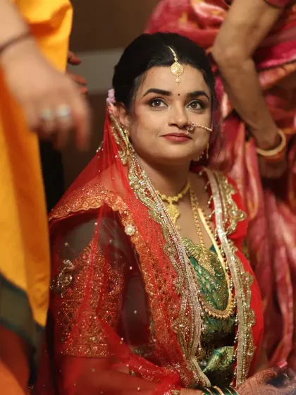 A candid shot of a bride during her wedding ceremony. The makeup was designed to be waterproof and long-lasting, ensuring she looked fresh and radiant throughout all the rituals.
