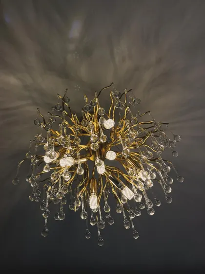 This stunning, branch-like chandelier is a true statement piece. It casts a beautiful, dappled light on the ceiling, acting as the centerpiece of the room and adding a huge dose of opulence and drama.