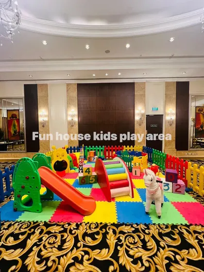 A full view of the rainbow play area, ready for party guests in a large, elegant room.