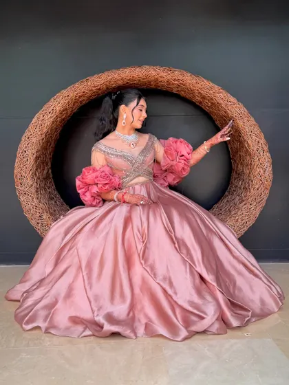 The bride posing in a large nest-like chair, looking like a character from a fairytale.