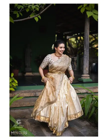Priyanka looking joyful and radiant in her traditional half saree. The makeup is light and fresh, perfect for a daytime ceremony at the beautiful Tamarind Tree venue.