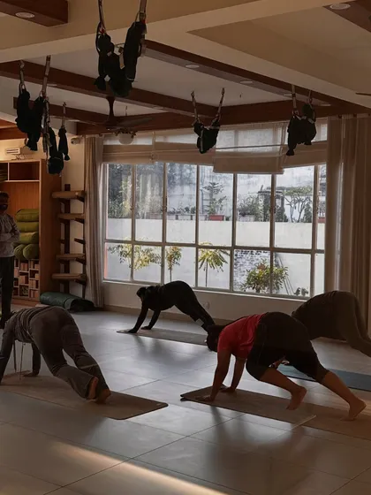 Students practice a plank variation, building core and upper body strength.