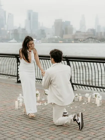 This is it. The moment the world stops. I worked with Monil to plan this surprise down to the second, hiding to capture that pure, unfiltered shock on Vishruti's face. Capturing this split-second of raw emotion against the New York skyline is what I live for.