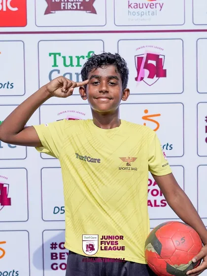 A player poses with a ball, full of confidence. My leagues are designed to build self-esteem and a love for the sport.