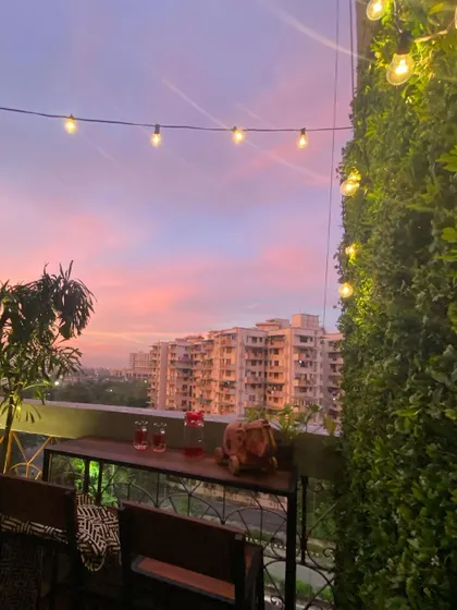 Even a small balcony can become your favorite breakaway spot. We installed a simple bar table, a vertical green wall, and festive string lights to make this space feel cozy and perfect for enjoying a beautiful evening sky.