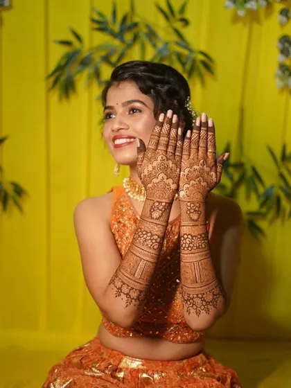 A joyful shot of a bride with her finished mehndi. My goal is to create art that you love and that makes you feel beautiful on your wedding day.