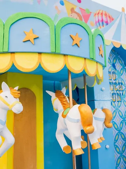 A close-up of the whimsical carousel prop. The detail and craftsmanship of these custom-built pieces are what make my event designs stand out.