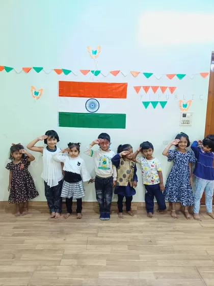 A duplicate of the previous image, showing our little Asters saluting the flag.