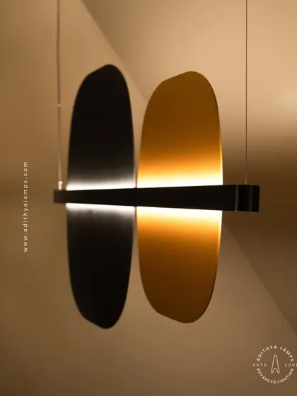 A study in balance and contrast, this fixture features opposing black and gold panels bisected by a line of light. This piece embodies the principle of yin and yang, offering a minimalist yet deeply symbolic lighting solution.
