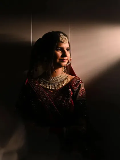 A dramatic bridal portrait using shadows and a single light source to create a moody and artistic feel.