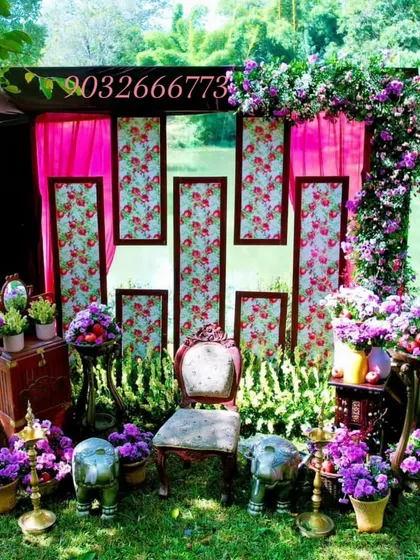 Another angle of the purple and pink themed outdoor ceremony decor, highlighting the floral arrangements and the central seating.